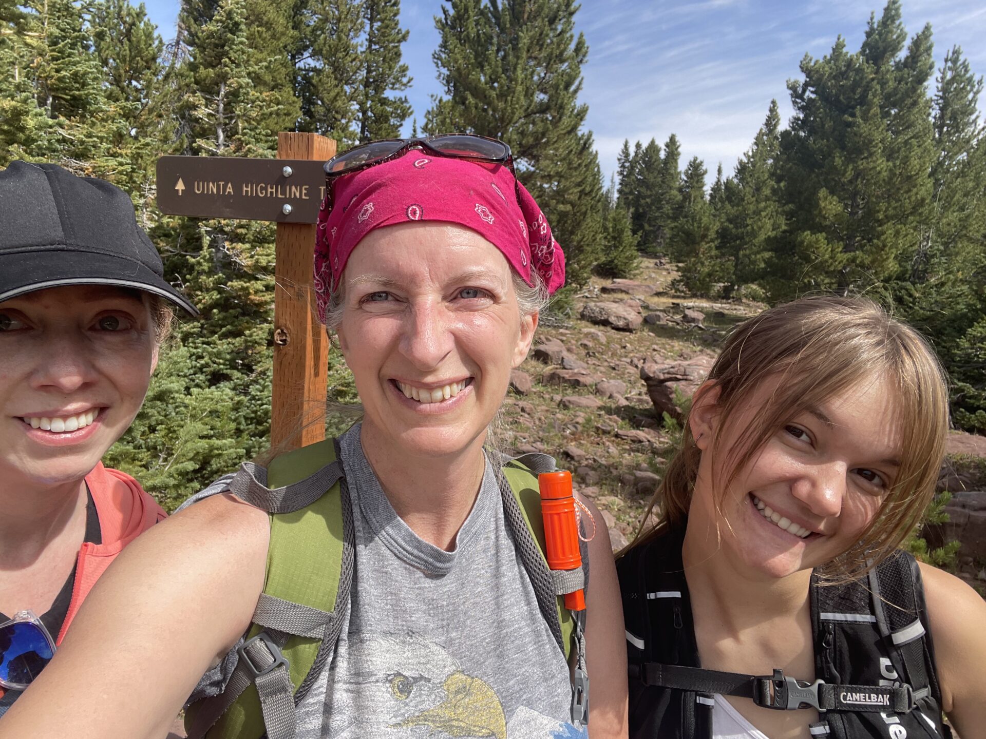 Three women hike along the Highline Trail